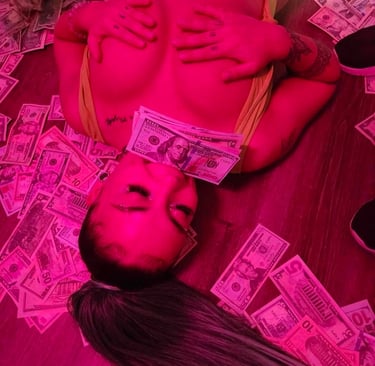 a woman laying on a table with money bills