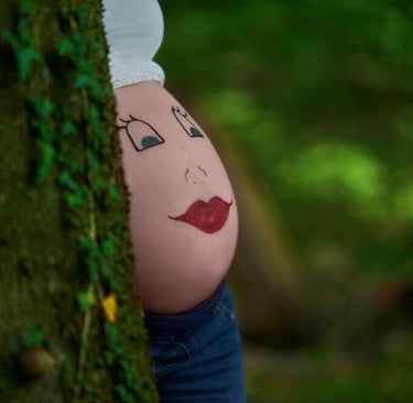 a pregnant belly in green woods
