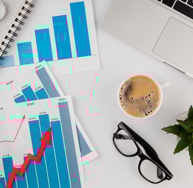 a cup of coffee and a laptop computer on a desk
