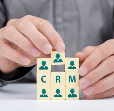 CRM concept with businessperson arranging cubes that represent customer relationship management strategy