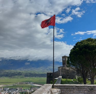 a albanian flag flying in the wind on a sunny day