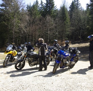 a group of people standing around a group of motorcycles
