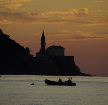a boat in the water at sunset
