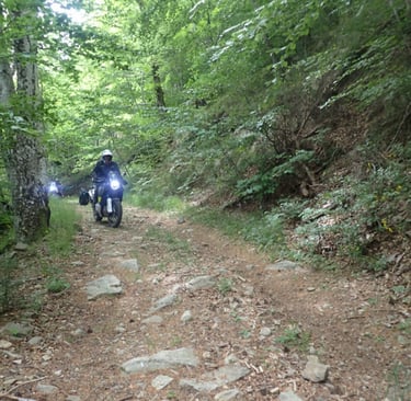 a person riding a motorcycle on a dirt road