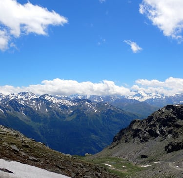a person on a mountain with a sky background