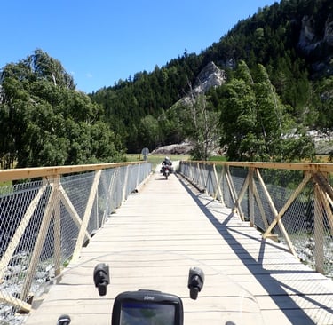 a motorcycle on an old bridge over a river