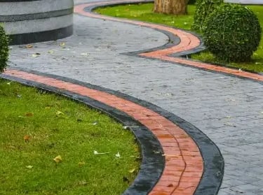 a red and clack concrete walkway