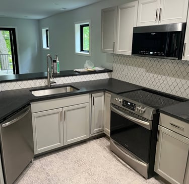 Annick Building Services, a kitchen with a stove top oven and a microwave