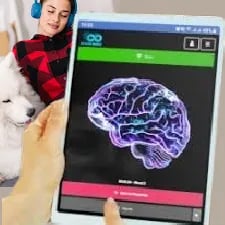 a person holding a tablet with a dog in front of a laptop