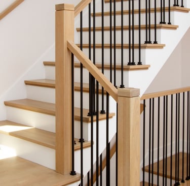 Modern wood stairs with solid oak rails and black iron balusters