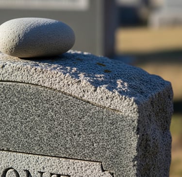 single stone set upon grave headstone