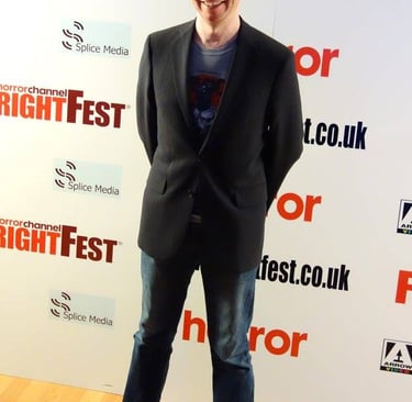 James Moran in front of the media wall at FrightFest