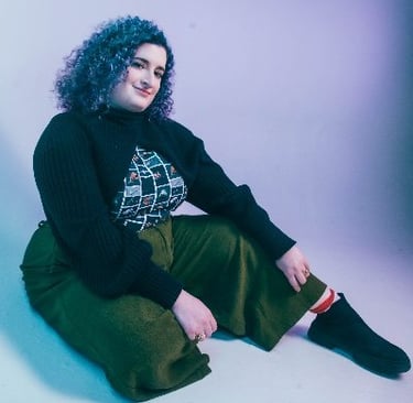 a woman with blue hair and a black sweater