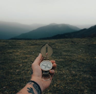 Holding compass over mountain trail, navigation and orienteering in wilderness