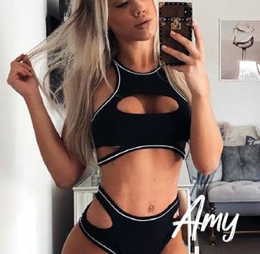 a woman in a black bikinisuit posing for a selfie