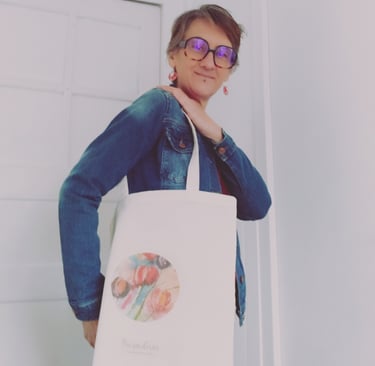a woman in glasses and a denim jacket is holding a bag