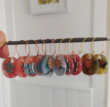 a person holding a bunch of buttons and earrings