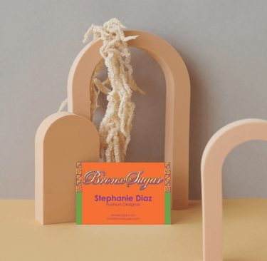 Bronx Sugar fashion designer business card displayed on aesthetic arch props.