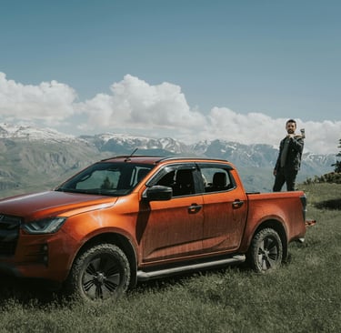 Orange Suzuki Pick-Up against mountain brackgraund