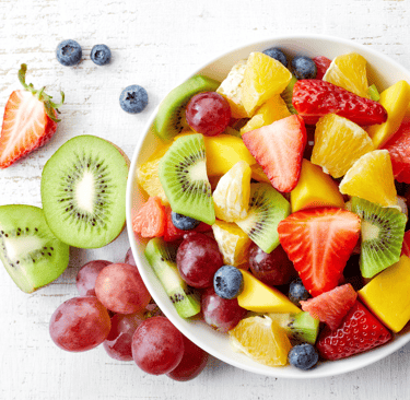 a bowl of fruit and fruit juice