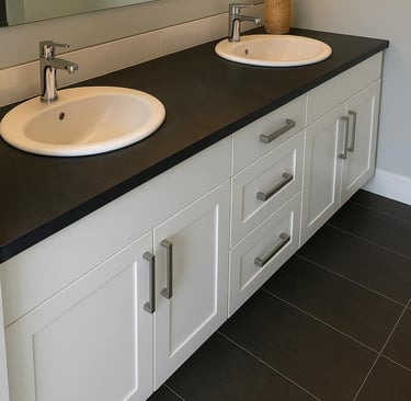 white vanity euro-style with two sinks and black countertop