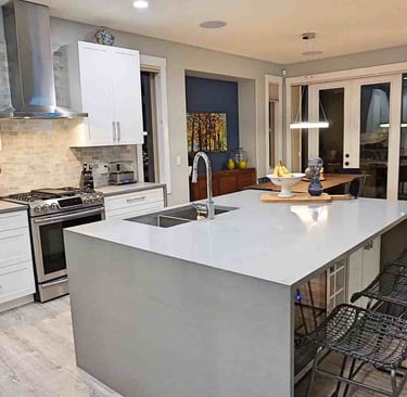 High gloss countertop and white kitchen cabinets euro-style in a kitchen in lake country
