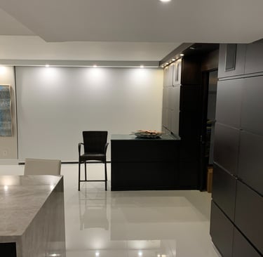 a kitchen with a large counter top and a bar stool