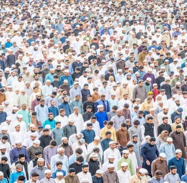 Large group of people gathered in prayer, standing closely together