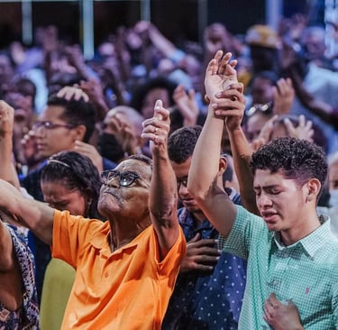 a group of people standing in a crowd worshipping God
