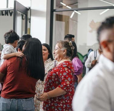a group of people standing around a table