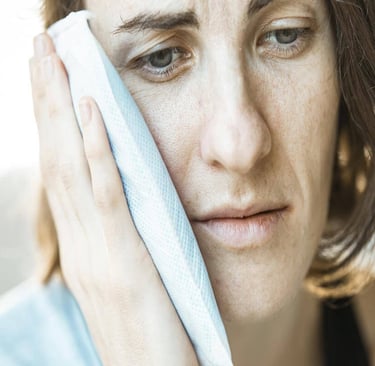 A woman with a towel on her head, in pain