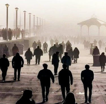 a group of people walking down a sidewalk