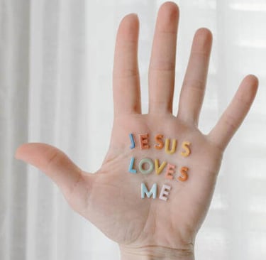 a person's hand with the words jesus loves me written on it