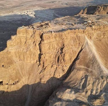 Aerial view of Masada fortress on a desert plateau overlooking the Dead Sea.