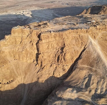 a mountain view of a cliff face in the desert