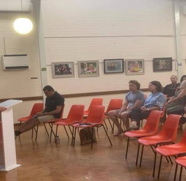 Salome speaking and teaching from a lectern to a seated church group.