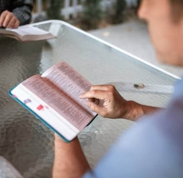 a man is holding a bible