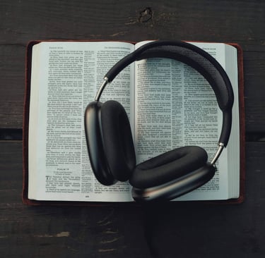 a bible opened with a headphones