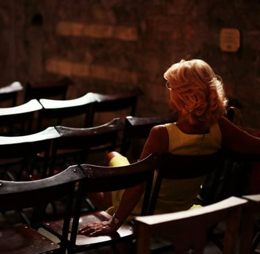 a woman sitting in a chair with a yellow dress