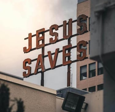 Building sign reading ‘Jesus Saves,’ expressing a message of faith and hope.