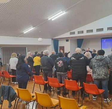Congregation standing together in worship during a church service.