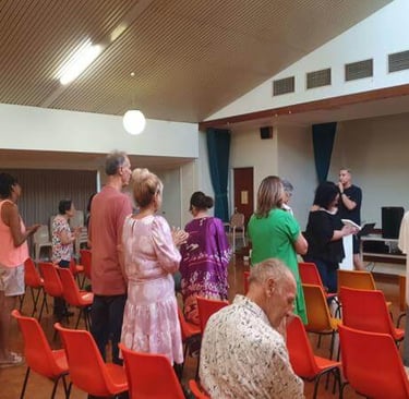 Church members standing and worshipping together during a service.