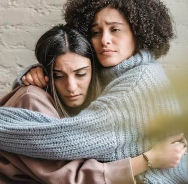 a woman in a sweater is hugging a friend