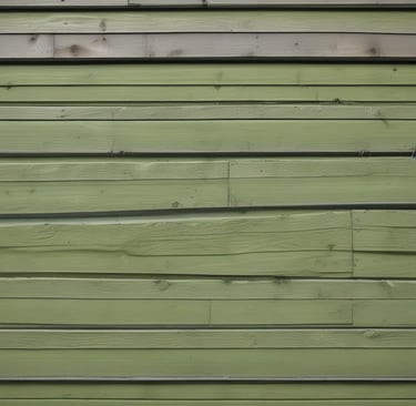 Close-up of siding with mold stains fading after soft washing treatment.