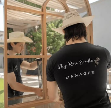 MyRose Events manager wearing a black T-shirt, arranging a table decoration.