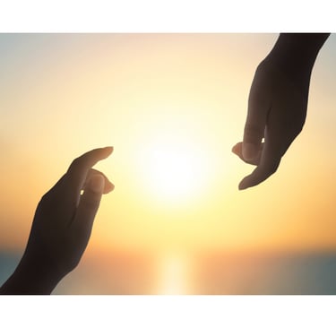 two hands reaching for the sun in the sky at golden hour
