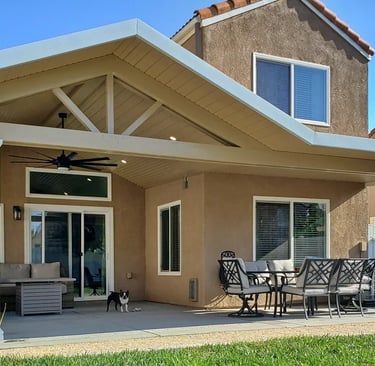 Alumawood patio cover with gable roof line, lights, and ceiling fan.