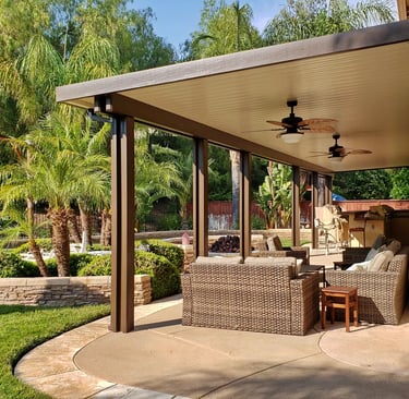 Newport style solid Alumawood patio cover with palm trees.