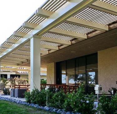 Large pergola over patio area and big sliding glass door.