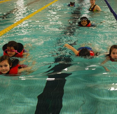 kids swimming in lifejackets